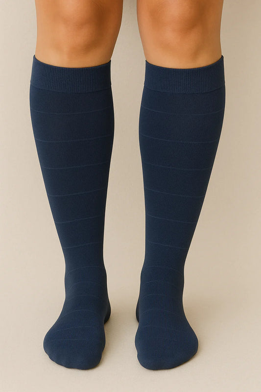 Navy Glowbump maternity compression socks on legs, designed to support circulation and reduce swelling